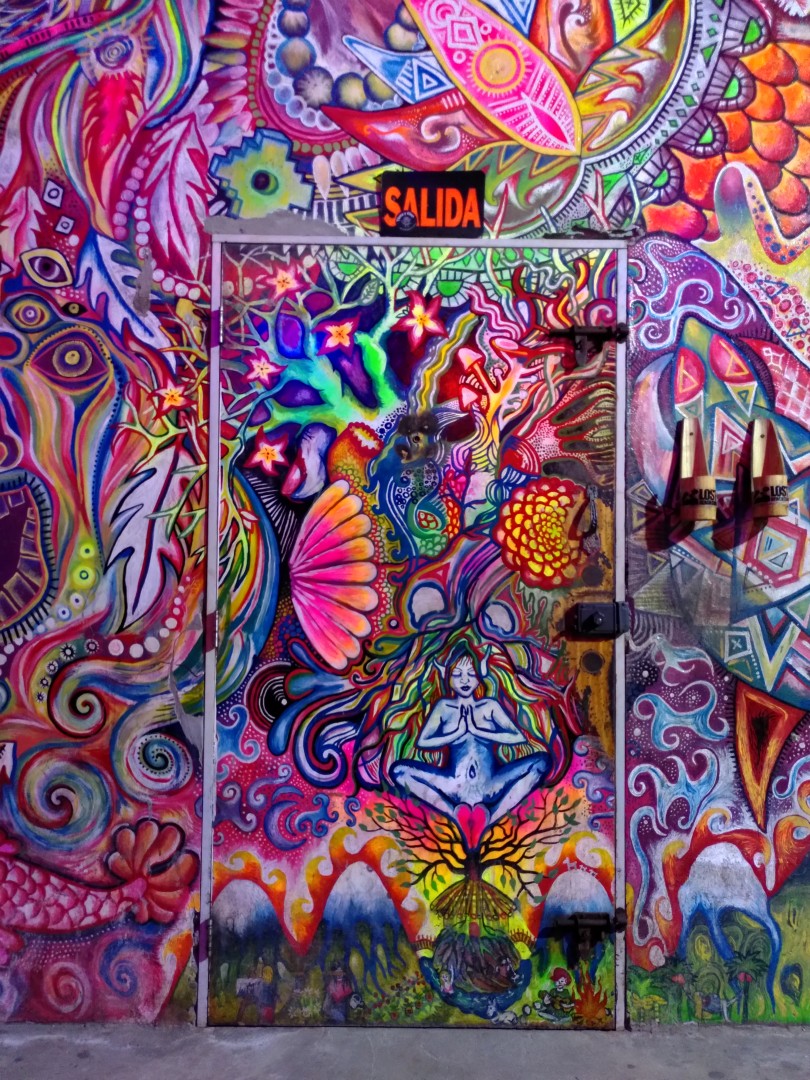 The front door and wall of Lost Beach Club from the inside, with a very colourful mural