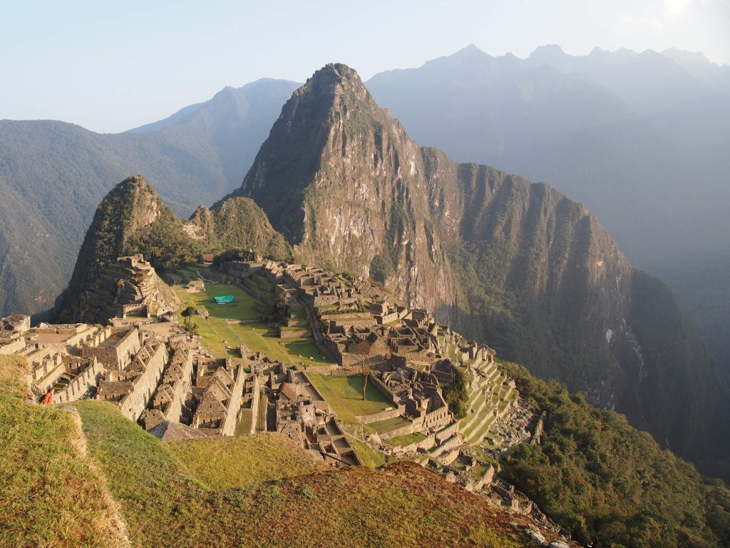 Remains of the Inka citadel known as Machu Picchu on top of jungle-covered mountains